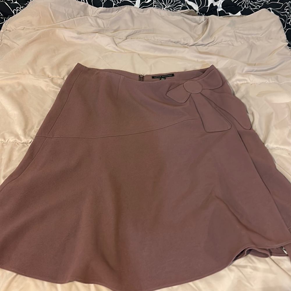 Woman’s mini skirt with bow design. A pastel purple.